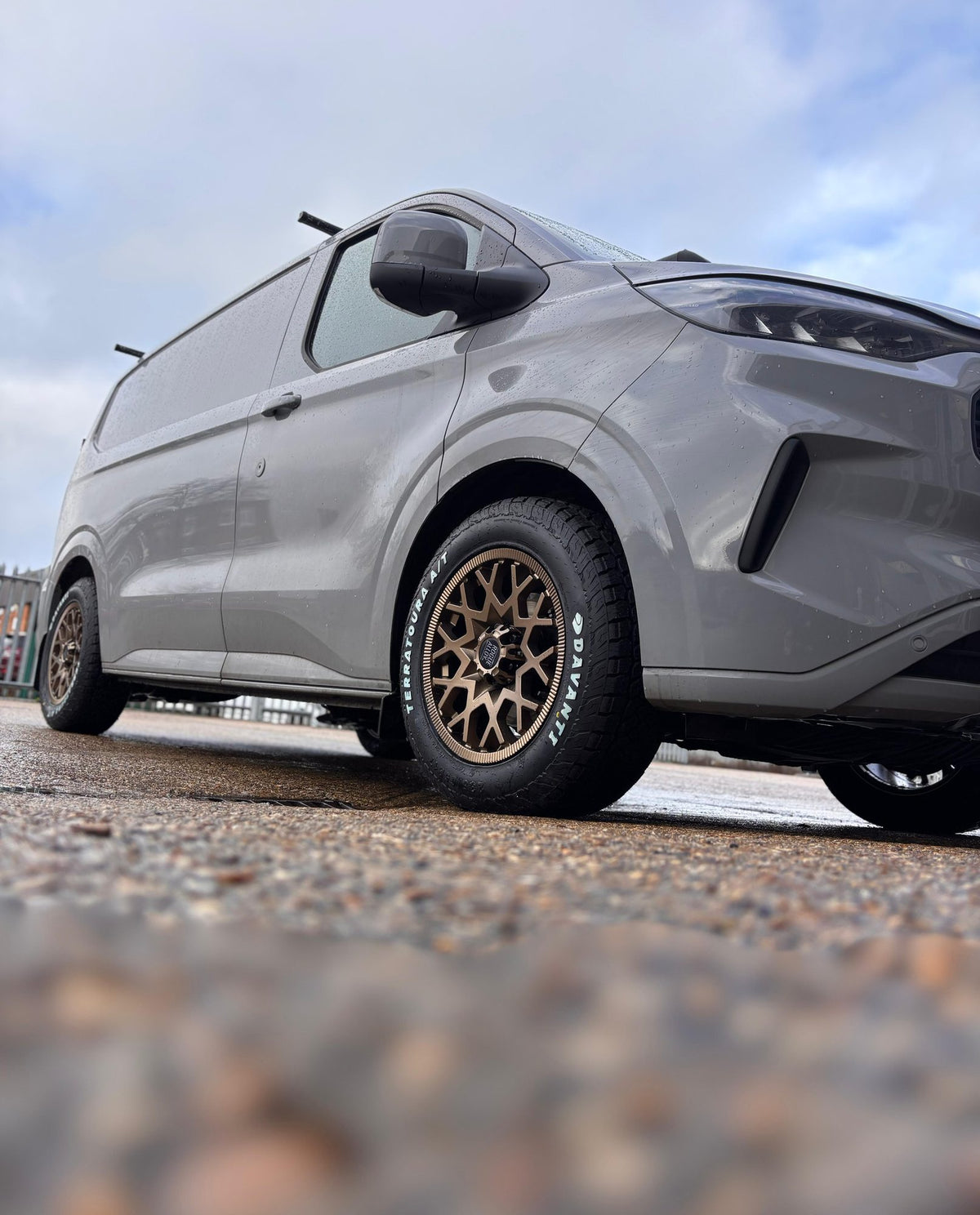 A grey Ford Transit Custom on bronze Rogue wheels and Davanti all-terrain tyres