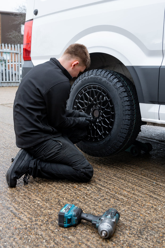 A black mesh Rogue wheel being fitted to a Volkswagen Crafter