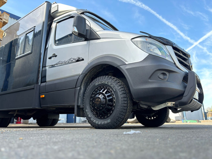 A Mercedes-Benz Sprinter 4x4 expedition conversion on black Rogue wheels